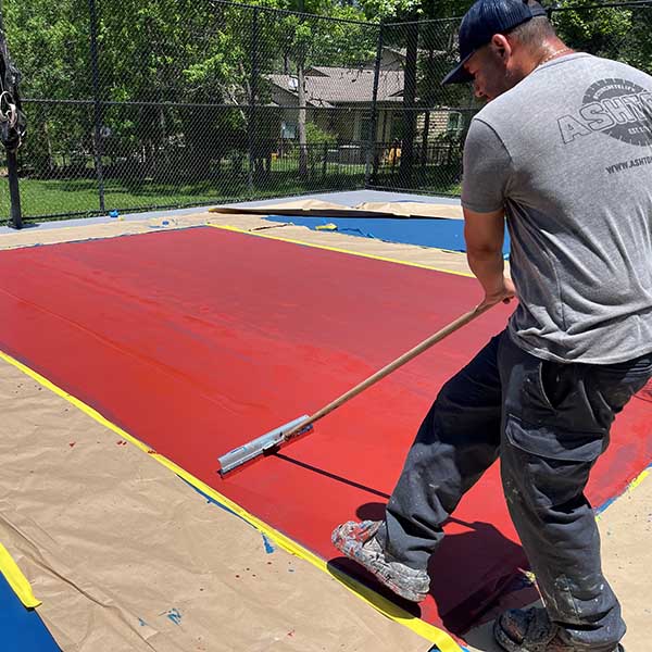 Worker installing Sports Coating