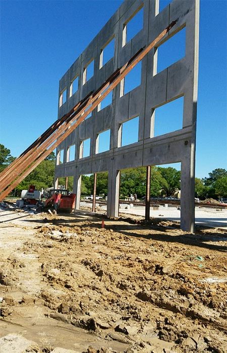 Large concrete wall under construction at Texas and Louisiana in Dallas, TX