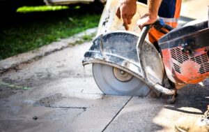 Construction worker cutting Asphalt paving for sidewalk