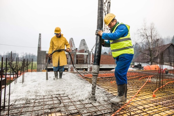 Construction workers pouring concrete at Ashton Sawing and Drilling