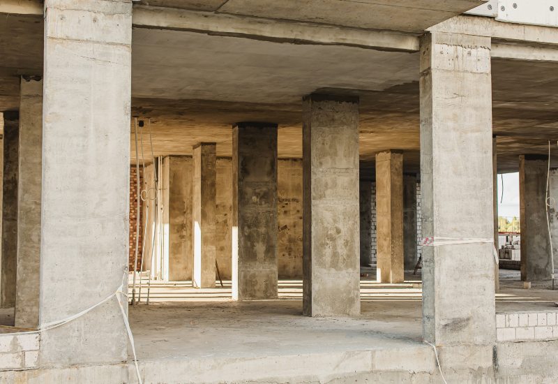 Interior of a concrete building under construction with load-bearing columns in Texas & Louisiana