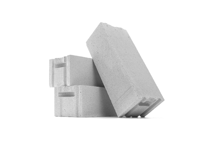 Stacked concrete blocks with one block leaning, isolated on a white background in Texas & Louisiana