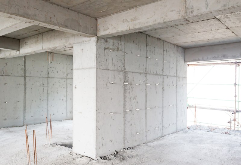 Unfinished concrete interior with beams and exposed rebar during construction in Texas & Louisiana